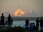 People watch as SpaceX's next-generation Starship spacecraft atop its powerful Super Heavy rocket lifts off from the company's Boca Chica launchpad in Texas on November 18.