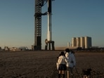 People look on as SpaceX's next-generation Starship spacecraft is prepared for test launch from the company's Boca Chica launchpad near Brownsville, Texas, on November 17.(Reuters)