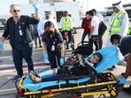 Volunteers transport a wounded Palestinian child off the plane upon arrival in Abu Dhabi. Volunteers transport a wounded Palestinian child off the plane upon arrival in Abu Dhabi.