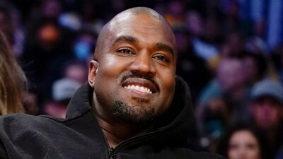 FILE - Kanye West, known as Ye, watches the first half of an NBA basketball game between the Washington Wizards and the Los Angeles Lakers in Los Angeles, March 11, 2022. Adidas saw operating earnings dwindle in the first three months of the year as the German sportswear company's breakup with the rapper formerly known as Kanye West and his popular Yeezy shoe brand cost it 400 million euros ($441 million) in lost sales. Profit was down to 60 million euros from 437 million euros in the same quarter a year ago, while profit margin shrank to a bare 1.1%. Net sales declined 1%, to 5.27 billion euros, and would have risen 9% with the Yeezy line, the company said Friday, May 5, 2023. (AP Photo/Ashley Landis, File) (AP) FILE - Kanye West, known as Ye, watches the first half of an NBA basketball game between the Washington Wizards and the Los Angeles Lakers in Los Angeles, March 11, 2022. Adidas saw operating earnings dwindle in the first three months of the year as the German sportswear company's breakup with the rapper formerly known as Kanye West and his popular Yeezy shoe brand cost it 400 million euros ($441 million) in lost sales. Profit was down to 60 million euros from 437 million euros in the same quarter a year ago, while profit margin shrank to a bare 1.1%. Net sales declined 1%, to 5.27 billion euros, and would have risen 9% with the Yeezy line, the company said Friday, May 5, 2023. (AP Photo/Ashley Landis, File) (AP)