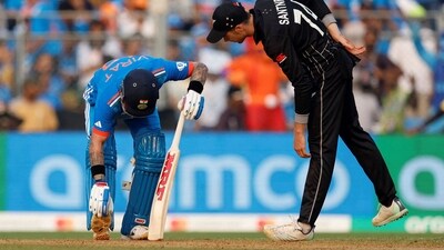 New Zealand's Mitchell Santner checks on India's Virat Kohli after he sustained an injury (REUTERS)