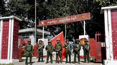 Members of the Myanmar National Democratic Alliance Army pose for a photograph in front of the seized army's infantry battalion in Kunlong township in Shan state, Myanmar on Nov. 12. (AP)