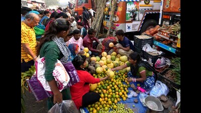 People buy fruits for Chhath Puja celebrations at Azadpur Mandi in New Delhi on Saturday. (PTI)