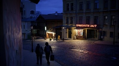 People walk at dusk in central Kyiv, Ukraine, (AP) People walk at dusk in central Kyiv, Ukraine, (AP)