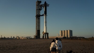 People look on as SpaceX's next-generation Starship spacecraft is prepared for test launch from the company's Boca Chica launchpad near Brownsville, Texas, on November 17. (Reuters)