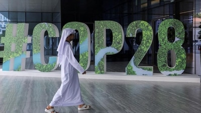 A person walks past a ‘#COP28’ sign during a workshop focused on climate action, in Abu Dhabi, United Arab Emirates. (REUTERS) A person walks past a ‘#COP28’ sign during a workshop focused on climate action, in Abu Dhabi, United Arab Emirates. (REUTERS)