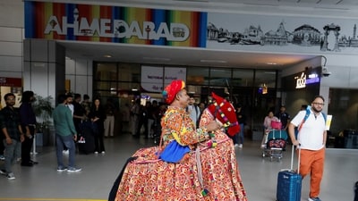 A folk dancer performs to welcome passengers arriving at Sardar Vallabhbhai Patel International Airport for the ICC Men's Cricket World Cup final between India and Australia. (Reuters)