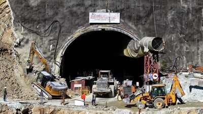 Rescue workers stand at an entrance of the under construction road tunnel, days after it collapsed in the Uttarkashi district of India's Uttarakhand state on November 18, 2023. (AFP) Rescue workers stand at an entrance of the under construction road tunnel, days after it collapsed in the Uttarkashi district of India's Uttarakhand state on November 18, 2023. (AFP)