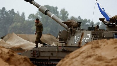 Israel-Hamas War: An Israeli soldier walks near a mobile artillery unit. (Reuters)