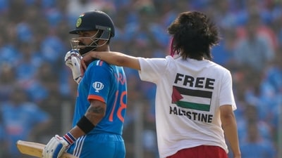 A Free Palestine protestor invades the pitch and puts his arm on the shoulder of India's Virat Kohli during the ICC Men's Cricket World Cup final (AP) A Free Palestine protestor invades the pitch and puts his arm on the shoulder of India's Virat Kohli during the ICC Men's Cricket World Cup final (AP)