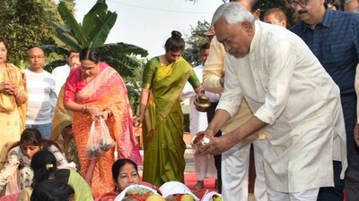 Bihar's Chief Minister Nitish Kumar joins in Chhath Puja festivities at his home in Patna on Sunday. (PTI)