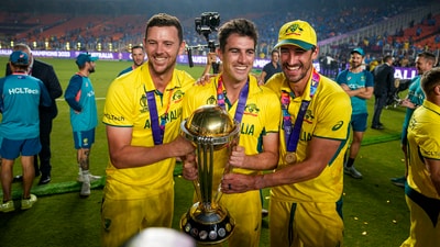 Australian captain Pat Cummins, Josh Hazlewood and Mitchell Starc pose for photographs with the World Cup trophy (PTI) Australian captain Pat Cummins, Josh Hazlewood and Mitchell Starc pose for photographs with the World Cup trophy (PTI)