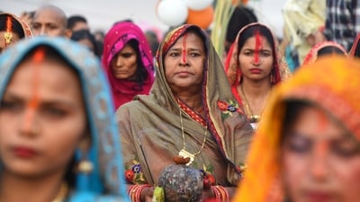 At Gurugram's Sheetla Mata Mandir Parking site, devotees pray to the setting sun and conduct Chhath rituals at the pond. (Parveen Kumar/HT Photo)