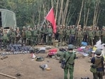Members of the Myanmar National Democratic Alliance Army pose for a photograph with the weapons allegedly seized from the Myanmar’s army outpost on a hill in Chinshwehaw town, Myanmar, on Oct. 28, 2023 (The Kokang” online media via AP)