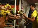 Australia's Pat Cummins celebrates with fans and the trophy after winning the ICC Cricket World Cup