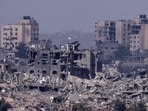 Israel-Hamas War: Israeli flags flying over destroyed buildings inside the Gaza Strip.