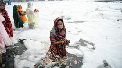 Devotees offer prayers to the setting sun on the banks of the polluted Yamuna river during the Chhath Puja celebrations Devotees offer prayers to the setting sun on the banks of the polluted Yamuna river during the Chhath Puja celebrations