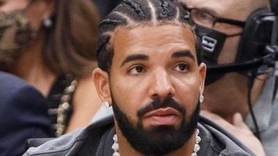 Photographer Brent Kore posted an image of the rapper's new art addition on his Instagram story, capturing the phrase “miskeen” in an arch over Drake's eye.