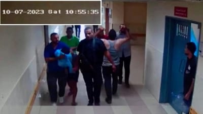 A screen grab of a video released by the Israeli army on November 19, 2023, shows security camera footage of what they say were the Hamas bringing in a hostage from Israel into the Shifa hospital on the day of the October 7 attack. (REUTERS)