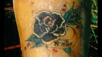 The woman had a prominent tattoo of a black flower with green leaves on her forearm, and had been “violently killed” (Interpol) The woman had a prominent tattoo of a black flower with green leaves on her forearm, and had been “violently killed” (Interpol)