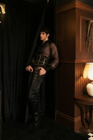 Sheer shirt styled with a corset belt.