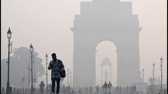 People walk along the Kartavya Path in front of the India Gate amid heavy smoggy conditions in New Delhi on November 13. Delhi regularly ranks among the most polluted major cities on the planet, with a melange of factory and vehicle emissions exacerbated by seasonal agricultural fires. (AFP)