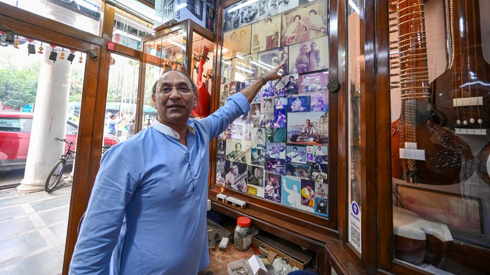 Ajay Rikhiram shows the pictures of The Beatles inside his store. (Photo by Sanchit Khanna/ Hindustan Times) Ajay Rikhiram shows the pictures of The Beatles inside his store. (Photo by Sanchit Khanna/ Hindustan Times)