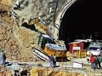 A heavy machinery works at the entrance to the site of an under-construction road tunnel that collapsed in Uttarakhand