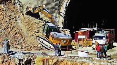 A heavy machinery works at the entrance to the site of an under-construction road tunnel that collapsed in Uttarakhand (HT_PRINT) A heavy machinery works at the entrance to the site of an under-construction road tunnel that collapsed in Uttarakhand (HT_PRINT)