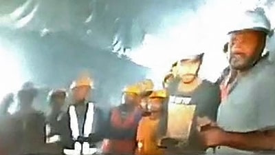 This picture released by Department of Information and Public Relation (DIPR) Uttarakhand and taken with endoscopic camera on November 21, 2023 shows a group of workers trapped inside the under-construction tunnel, days after it collapsed in the Uttarkashi district of India's Uttarakhand state. (via HT)