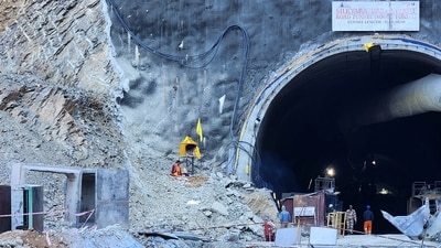 A Hindu priest prays at a makeshift shrine outside the entrance of a tunnel where workers are trapped after a portion of the tunnel collapsed in Uttarkashi. (REUTERS)