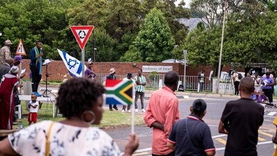 Members of the Active African Christians United Movements (AACUM) stand on and wave South African and Israeli flags as others gather in support of Israel outside of the embassy of Israel in Pretoria. (AFP) Members of the Active African Christians United Movements (AACUM) stand on and wave South African and Israeli flags as others gather in support of Israel outside of the embassy of Israel in Pretoria. (AFP)