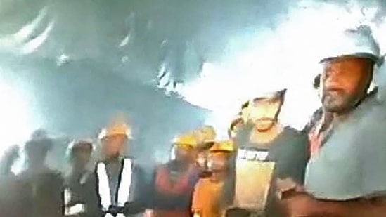 This picture released by Department of Information and Public Relation (DIPR) Uttarakhand and taken with endoscopic camera on November 21, 2023 shows a group of workers trapped inside the under-construction tunnel, days after it collapsed in the Uttarkashi district of India's Uttarakhand state. This picture released by Department of Information and Public Relation (DIPR) Uttarakhand and taken with endoscopic camera on November 21, 2023 shows a group of workers trapped inside the under-construction tunnel, days after it collapsed in the Uttarkashi district of India's Uttarakhand state.