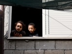 Israel-Hamas War: Palestinian children look outside a window in the aftermath of an Israeli raid in Tulkarm, in the Israeli-occupied West Bank.