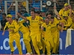 Australia's captain Pat Cummins, center, and teammates run to celebrate after their win in the ICC Men's Cricket World Cup final match against India.