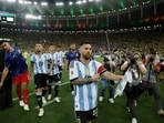 Argentina's Lionel Messi and teammates leave the pitch as fans clash with security staff in the stands causing a delay to the start of the match.