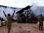 A soldier gestures as an Israeli artillery unit in Upper Galilee in northern Israel fires toward southern Lebanon on November 22, 2023.