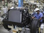 Workers labour at a chassis assembly line on the Innova Crysta compact multi-purpose vehicle (MPV) production line at the Toyota Kirloskar Motor Ltd. plant in Bidadi, Karnataka. Workers labour at a chassis assembly line on the Innova Crysta compact multi-purpose vehicle (MPV) production line at the Toyota Kirloskar Motor Ltd. plant in Bidadi, Karnataka.