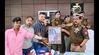 DG (Fire) Avinash Chandra releasing posters on traffic rule awareness made by the Ajay and Durgesh (sourced) (Sourced)