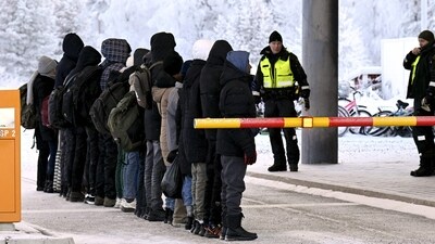 Migrants stand in a line in front of Finnish Border Guards at the international border crossing at Salla, northern Finland. (AFP) Migrants stand in a line in front of Finnish Border Guards at the international border crossing at Salla, northern Finland. (AFP)