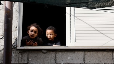 Israel-Hamas War: Palestinian children look outside a window in the aftermath of an Israeli raid in Tulkarm, in the Israeli-occupied West Bank. (Reuters)