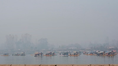 Boatmen row their 'shikaras' carrying tourists on Dal Lake amid dense fog, in Srinagar. (PTI) Boatmen row their 'shikaras' carrying tourists on Dal Lake amid dense fog, in Srinagar. (PTI)