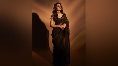 Rashmika wore the saree with a matching sleeveless blouse featuring a plunging V neckline highlighting her decolletage, a cropped hem showing off her midriff, and a fitted bust. She accessorised the six yards with a gold polki choker necklace, matching statement ring, and high heels. (Instagram) Rashmika wore the saree with a matching sleeveless blouse featuring a plunging V neckline highlighting her decolletage, a cropped hem showing off her midriff, and a fitted bust. She accessorised the six yards with a gold polki choker necklace, matching statement ring, and high heels. (Instagram)