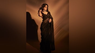 Rashmika wore the saree with a matching sleeveless blouse featuring a plunging V neckline highlighting her decolletage, a cropped hem showing off her midriff, and a fitted bust. She accessorised the six yards with a gold polki choker necklace, matching statement ring, and high heels. Lastly, feathered brows, smoky eye shadow, kohl-lined eyes, smudged eyeliner, glossy brown lip shade, mascara on the lashes, glowing skin, and side-parted open wavy locks completed the glam picks. (Instagram) Rashmika wore the saree with a matching sleeveless blouse featuring a plunging V neckline highlighting her decolletage, a cropped hem showing off her midriff, and a fitted bust. She accessorised the six yards with a gold polki choker necklace, matching statement ring, and high heels. Lastly, feathered brows, smoky eye shadow, kohl-lined eyes, smudged eyeliner, glossy brown lip shade, mascara on the lashes, glowing skin, and side-parted open wavy locks completed the glam picks. (Instagram)