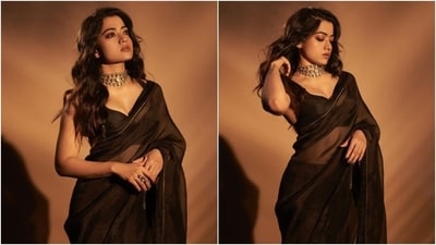 Rashmika Mandanna delighted her followers recently with pictures from a recent photoshoot. The snippets showed her in a black tissue silk saree and matching sleeveless blouse. The star styled the six yards elegantly with striking accessories and makeup, making her look the perfect show-stealing pick for the wedding season. Scroll through to check out Rashmika's outfit and read our download on her styling. (Instagram) Rashmika Mandanna delighted her followers recently with pictures from a recent photoshoot. The snippets showed her in a black tissue silk saree and matching sleeveless blouse. The star styled the six yards elegantly with striking accessories and makeup, making her look the perfect show-stealing pick for the wedding season. Scroll through to check out Rashmika's outfit and read our download on her styling. (Instagram)