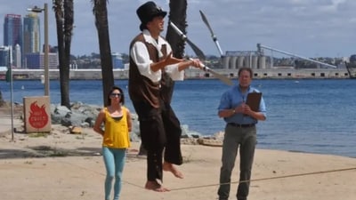 Man walking on slackline while juggling three knives. (Guinness World Record) Man walking on slackline while juggling three knives. (Guinness World Record)