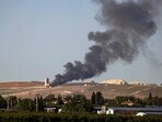 Flames and smoke rising from an agricultural structure in southern Lebanon's Khiam plain following Israeli bombardment.