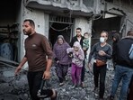 People flee following an Israeli strike in Rafah in the southern Gaza Strip on November 23, 2023. People flee following an Israeli strike in Rafah in the southern Gaza Strip on November 23, 2023.