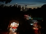 The Downtown Los Angeles skyline is seen as motorists make their way in and out of Los Angeles on November 22, 2023 as millions of people head to their Thanksgiving destinations. (Photo by Frederic J. BROWN / AFP)