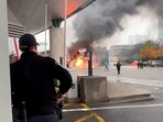 A Customs and Border Protection officer watches as a vehicle burns at the Rainbow Bridge U.S. border crossing with Canada, in Niagara Falls, New York, U.S. November 22, 2023.  Courtesy Saleman Alwishah via REUTERS